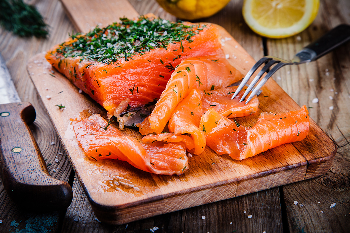 homemade smoked salmon with dill on a wooden table